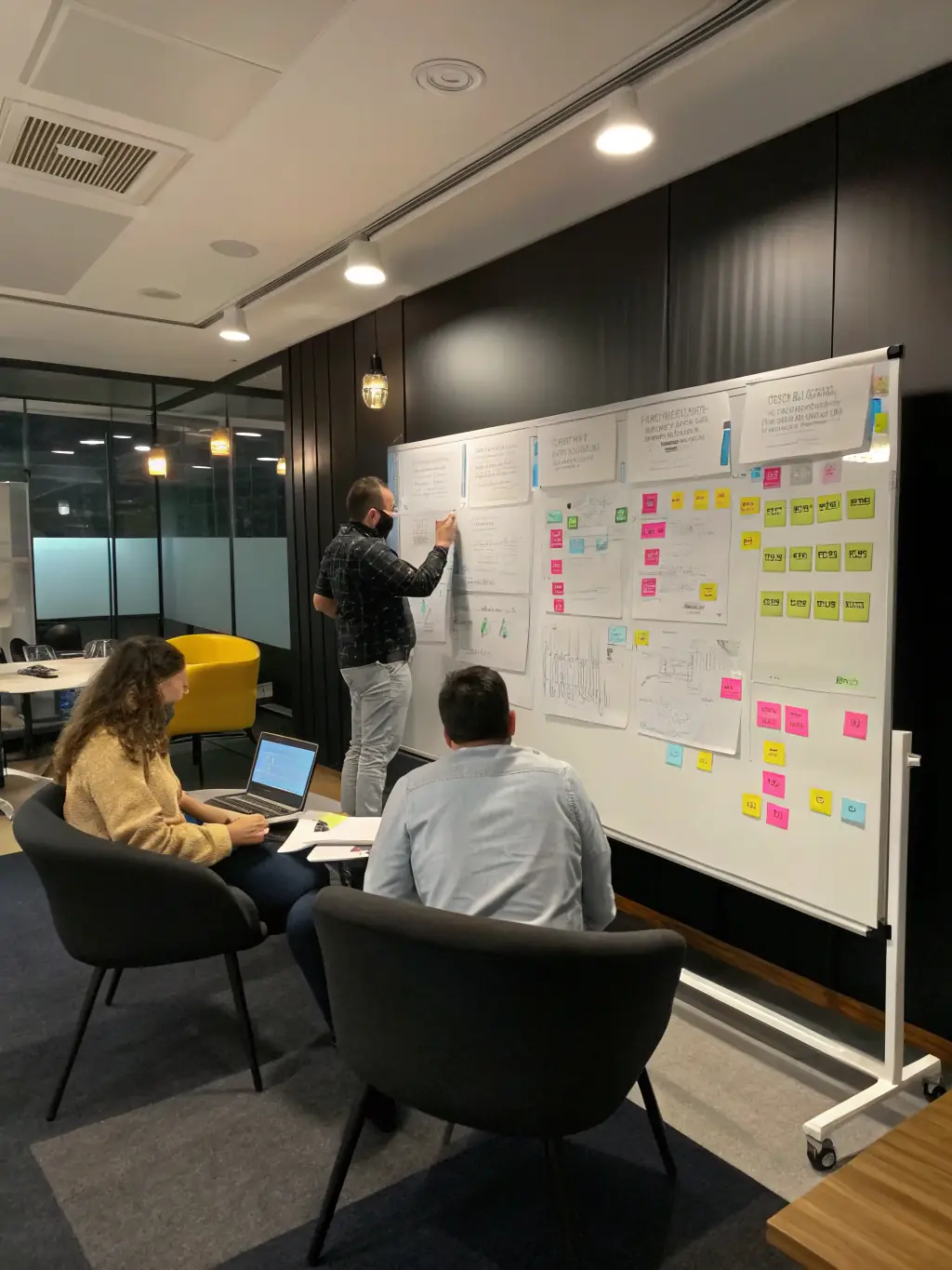 A coach facilitating a brainstorming session with a team, using sticky notes and a whiteboard to generate innovative ideas.